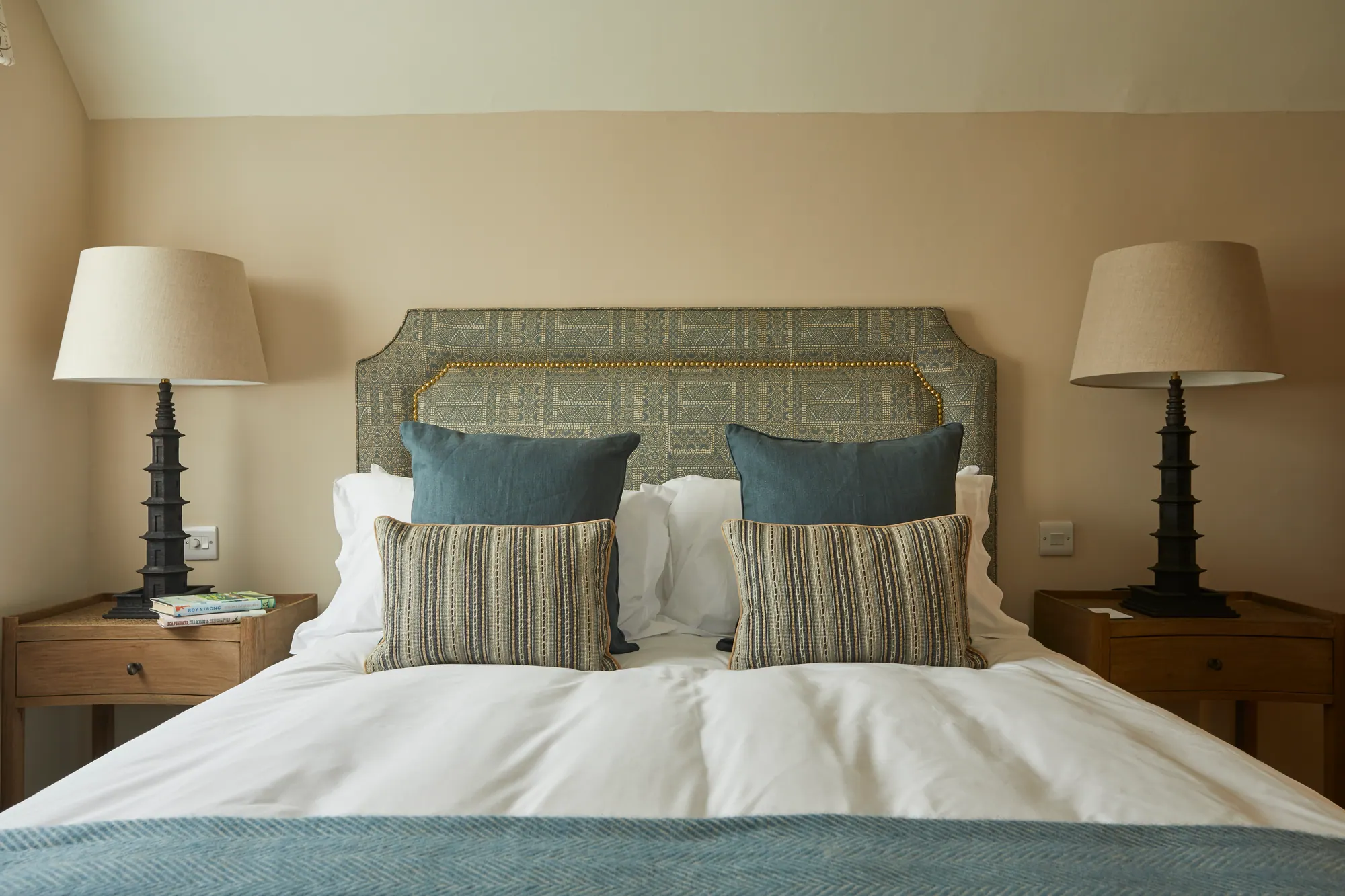Manor: a blue-grey headboard and pagoda-style lamps
