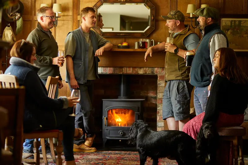 A lively crowd gathered round the log burner in the panelled bar, with two black dogs at their feet